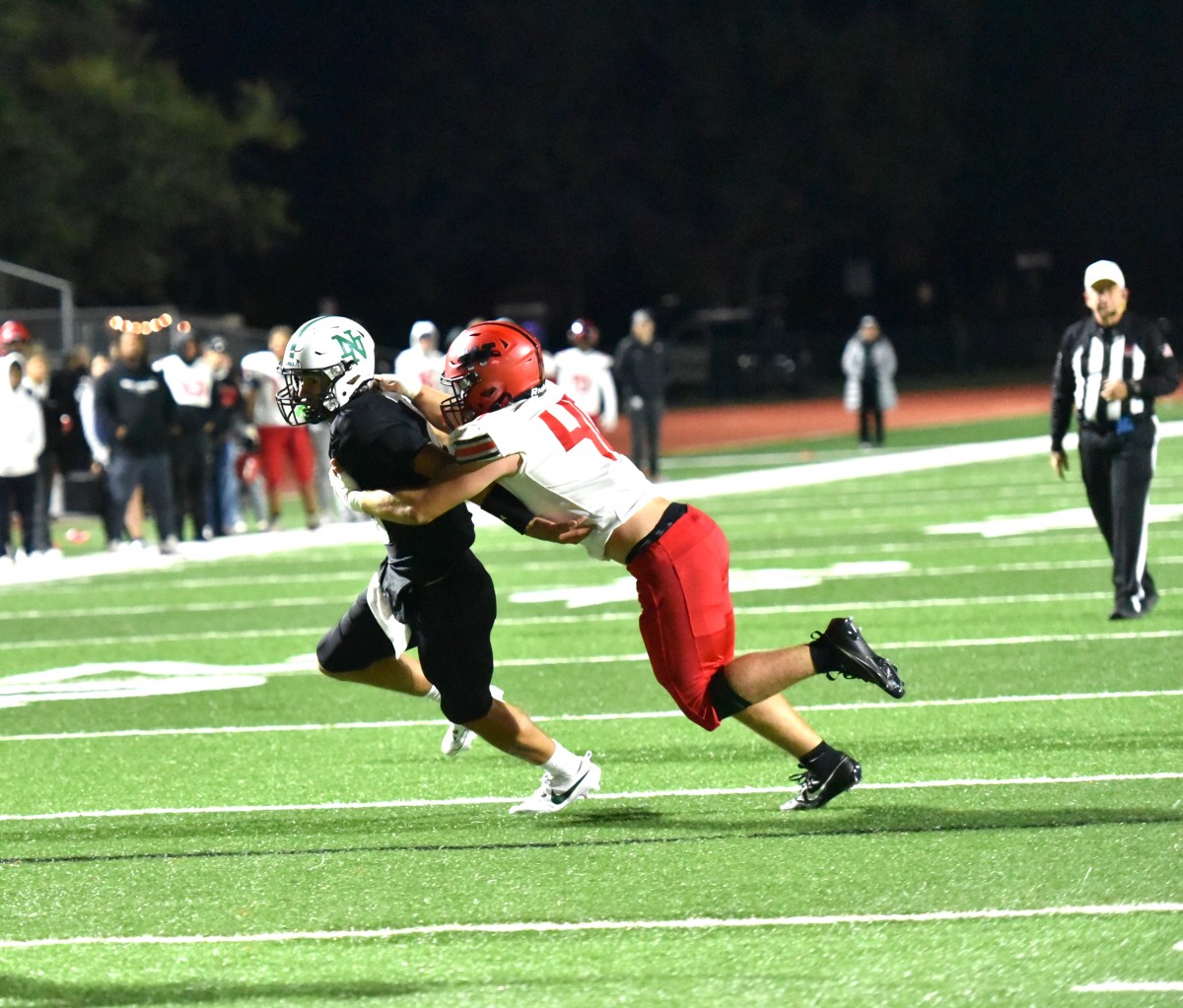 Westmoore linebacker Connor Cavnar (right) makes a tackle on a Norman North ballcarrier during a recent game. 